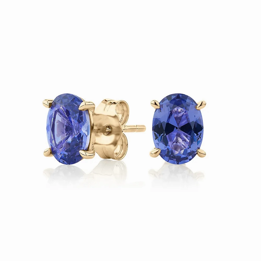 Oval stud earrings with tanzanite simulants in 10 carat yellow gold